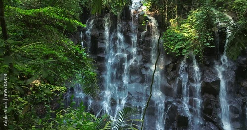 Kanto Lampo waterfall in lush tropical forest, Bali, Indonesia