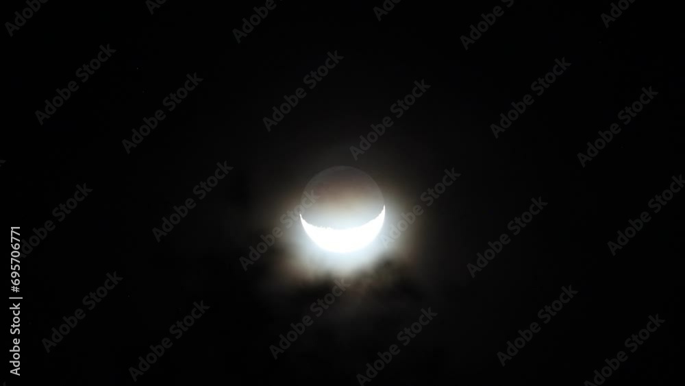 Crescent moon and dark night sky with silhouette of trees. Mysterious and moody nature scene. Crescent moon and dark night sky with silhouette of trees. Mysterious and moody nature scene.
