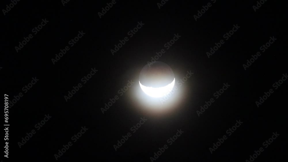 Crescent moon and dark night sky with silhouette of trees. Mysterious and moody nature scene. Crescent moon and dark night sky with silhouette of trees. Mysterious and moody nature scene.