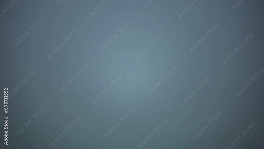 A wooded mountain area is completely made invisible by the rising fog.