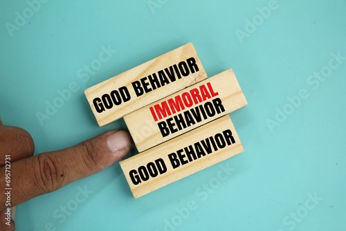 wood with the words good behavior and immoral behavior. the concept of behavior or ethics. the word immoral behavior is rejected