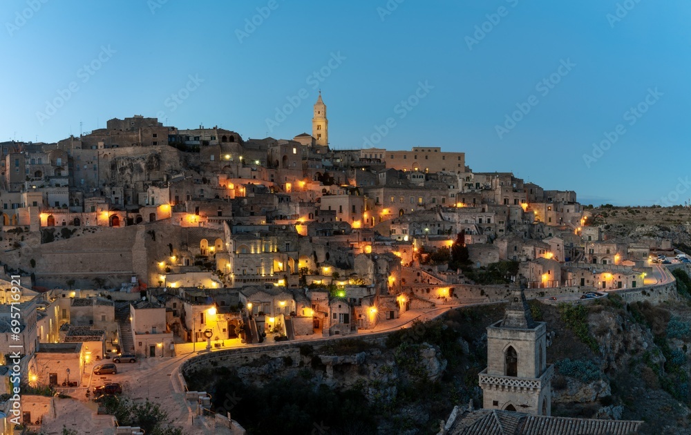 view of the old town of Matera after sunset with the lights coming on