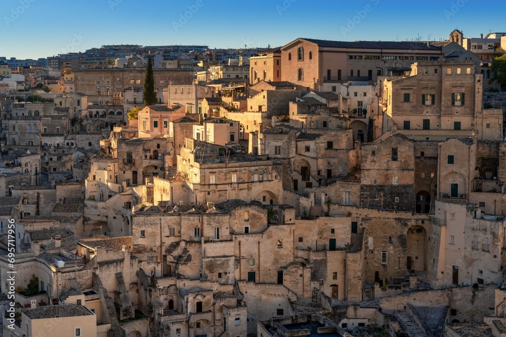 view of the old city center of Matera with the stone houses in the last rays of sunlight