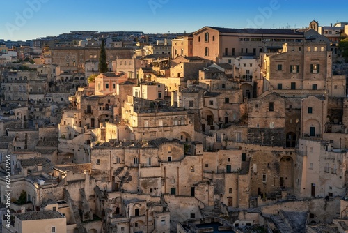 view of the old city center of Matera with the stone houses in the last rays of sunlight