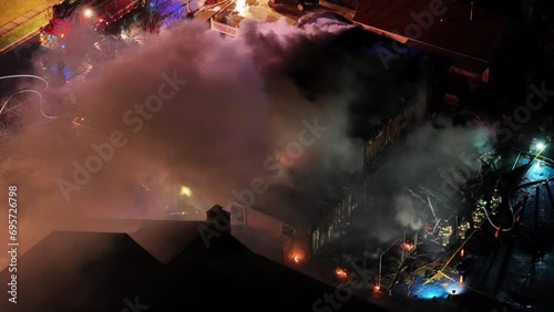 Aerial View of a House Fire With Flames and Smoke Through the Roof
