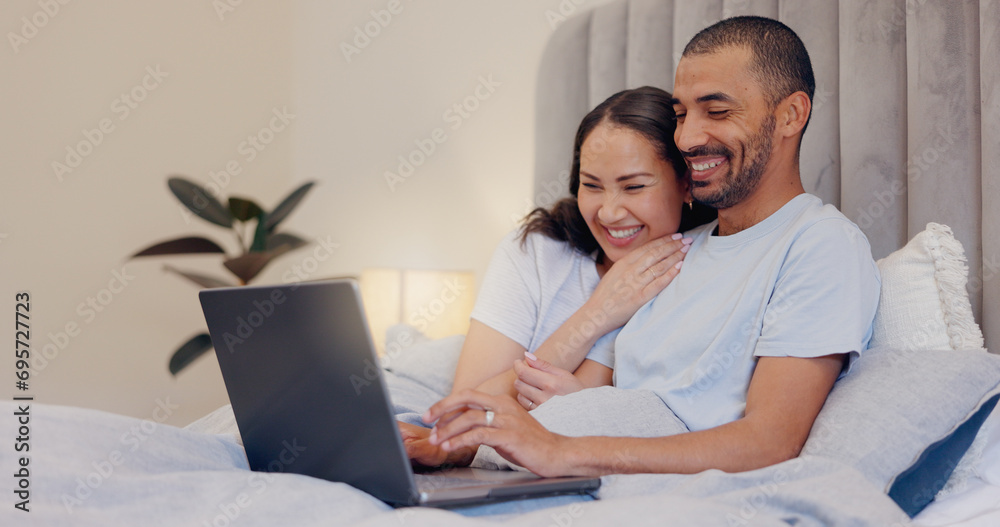 Laptop, happy and young couple in bed watching movie, film or show together at home. Smile, technology and man and woman relaxing in bedroom streaming a video on computer for bonding at modern house. Laptop, happy and young couple in bed watching movie, film or show together at home. Smile, technology and man and woman relaxing in bedroom streaming a video on computer for bonding at modern house.