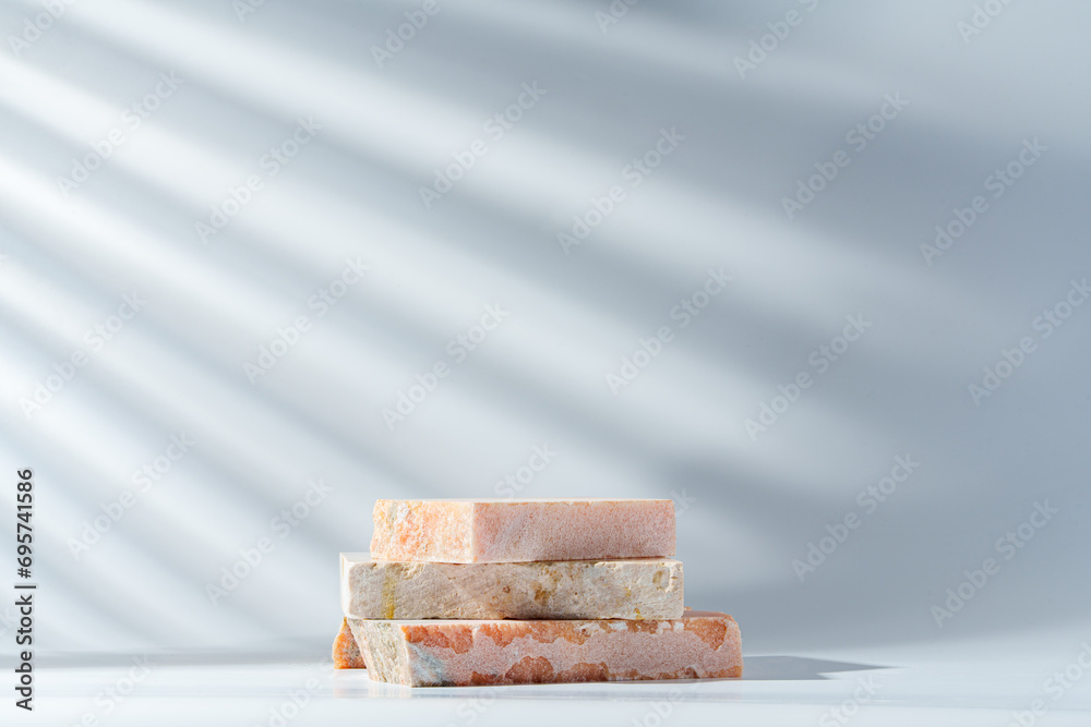 Piece of granite stone on white background with shadows Piece of granite stone on white background with shadows
