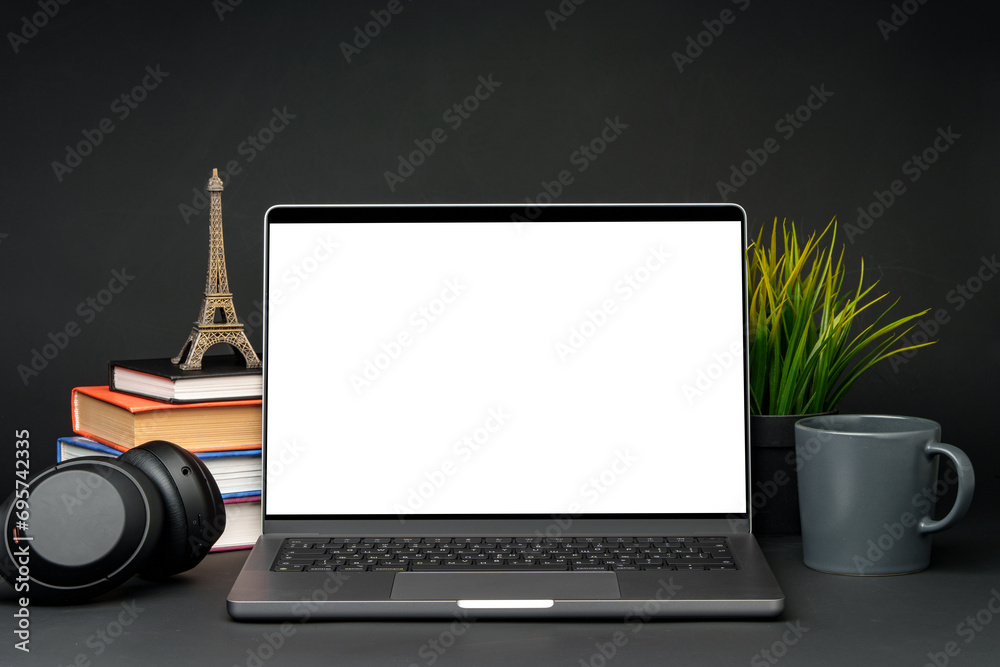 Fototapeta premium Laptop with blank screen on table against black background