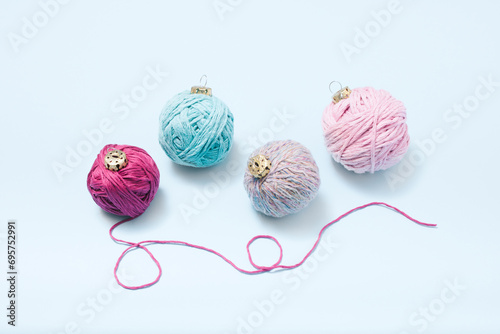 Christmas ornament concept made of colorful yarn balls. Minimal winter holliday idea.