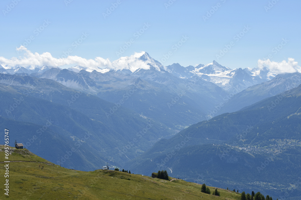 Wide Swiss Alps Panorama with Grassy Patch in Bottom Left Frame