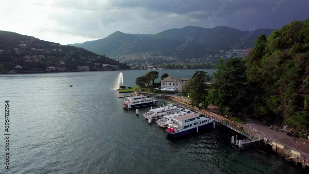 Aerial over boats docked in Lake Como near Como fountain, Italy Aerial over boats docked in Lake Como near Como fountain, Italy