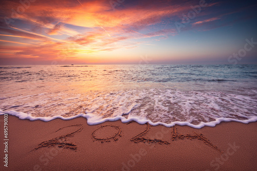 Fototapeta Naklejka Na Ścianę i Meble -  Happy New Year 2024 concept, lettering on the beach. Written text on the sea beach at sunrise.