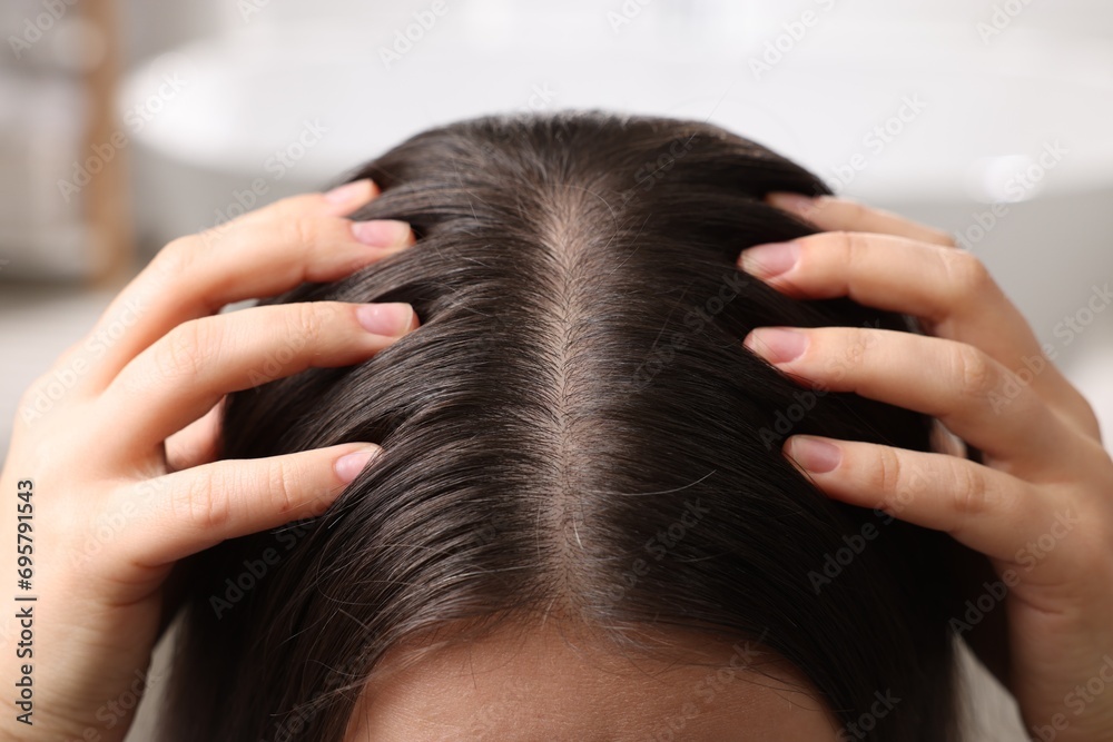 Woman examining her hair and scalp on blurred background, closeup - obrazy, fototapety, plakaty 