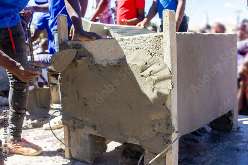 A concrete washboard being shaped with a gauging towel in a construction workshop