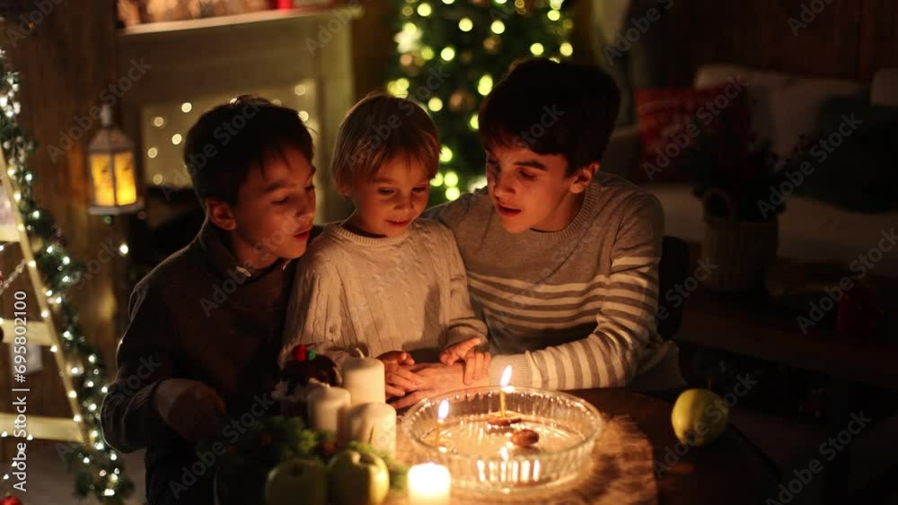 Three children, lighting candles in a nutshell, czech Christmas traditions, decorated room, family traditions Three children, lighting candles in a nutshell, czech Christmas traditions, decorated room, family traditions