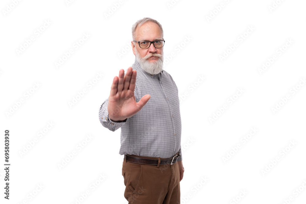 stylish successful grandfather with a white beard and mustache is dressed in a shirt and trousers on a white background with copy space stylish successful grandfather with a white beard and mustache is dressed in a shirt and trousers on a white background with copy space