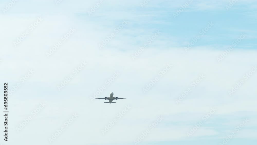 An airplane captured from its underside as it is taking off revealing a blue sky and clouds, airport in Thailand. An airplane captured from its underside as it is taking off revealing a blue sky and clouds, airport in Thailand.