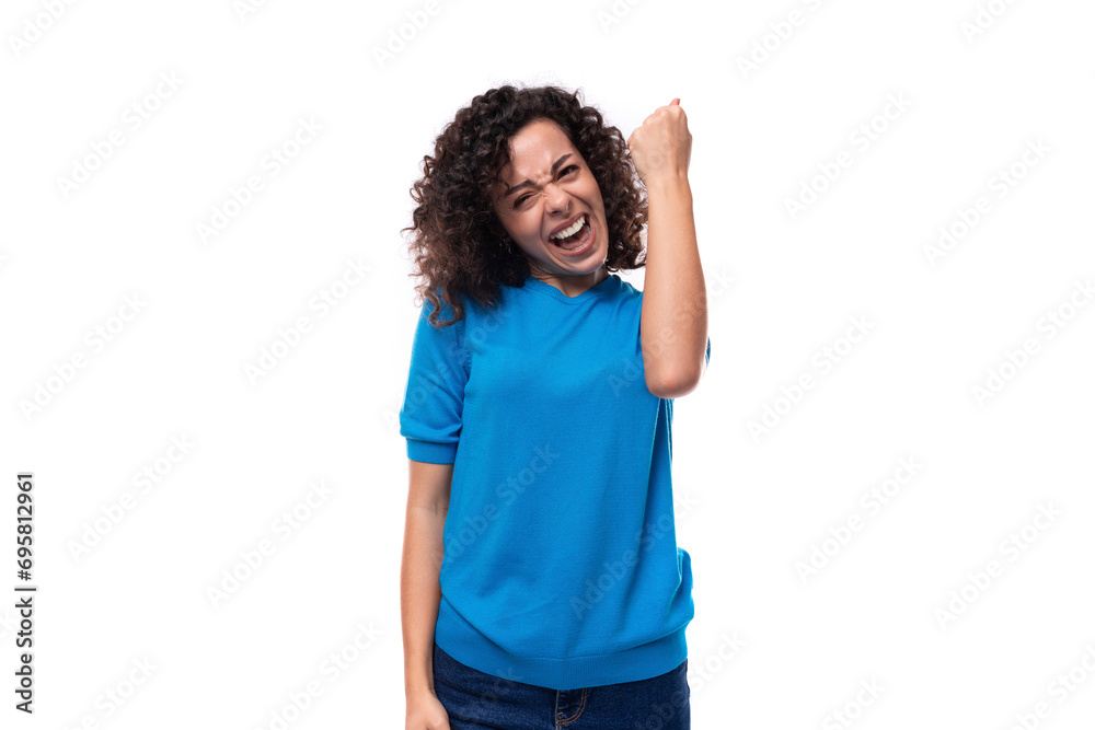 young curly woman in a blue sweater is experiencing happiness young curly woman in a blue sweater is experiencing happiness