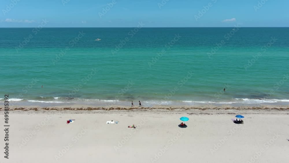 Over the seashore, beach, waves, sun, blue sky, white clouds. Filming from a drone. Over the seashore, beach, waves, sun, blue sky, white clouds. Filming from a drone.