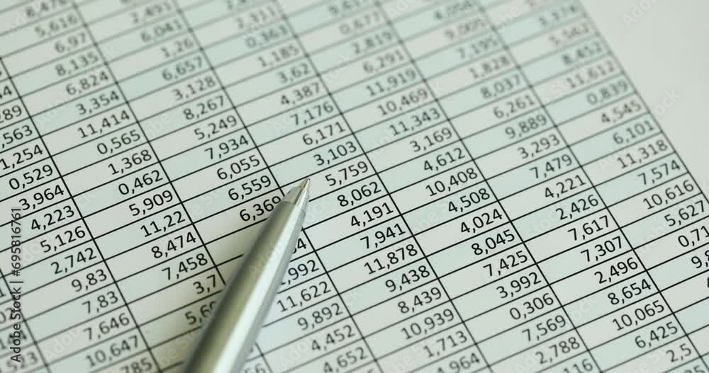 Pen lies on report with numbers closeup. Financial fraud or trading Pen lies on report with numbers closeup. Financial fraud or trading
