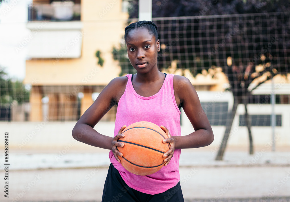 Confident Basketball Player Holding Ball with Determination