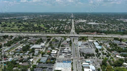 Flight over the roofs of houses, road, bridge, sea, cars, Hollywood, Miami. Filming from a drone.