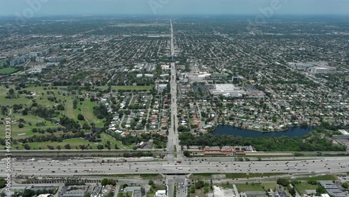 Flight over the roofs of houses, road, bridge, sea, cars, Hollywood, Miami. Filming from a drone.
