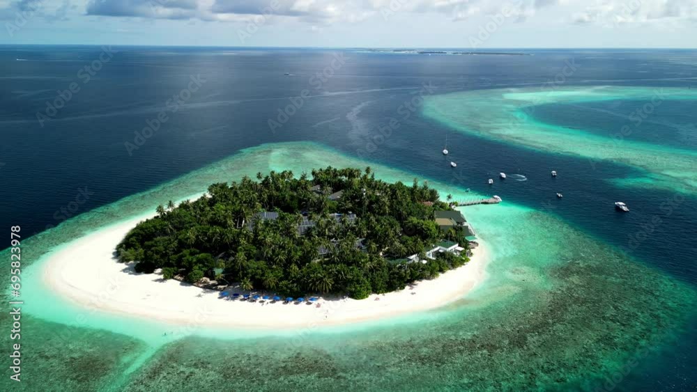 Tropical Island Paradise - Malahini Kuda Bandos, Maldives: Aerial drone anticlockwise rotate from far