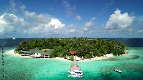 Tropical Island Paradise - Malahini Kuda Bandos, Maldives: Aerial drone rise up, reveal island and Bandos sister island backdrop photo