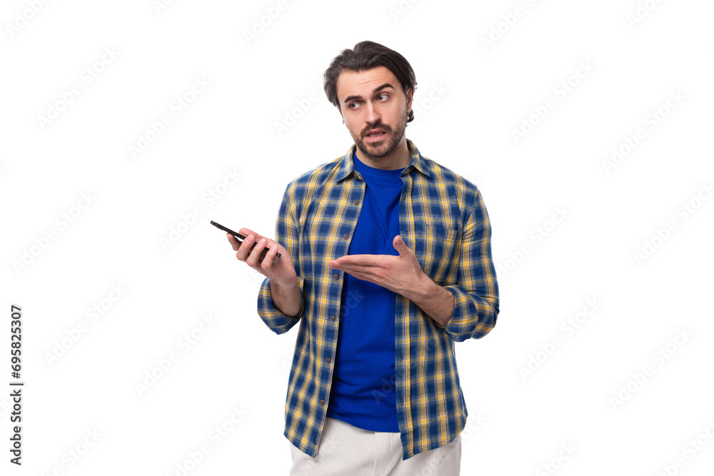 smart brunette macho man with a beard and mustache in a blue shirt on a white background with copy space smart brunette macho man with a beard and mustache in a blue shirt on a white background with copy space