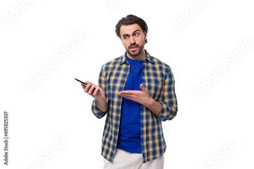 smart brunette macho man with a beard and mustache in a blue shirt on a white background with copy space