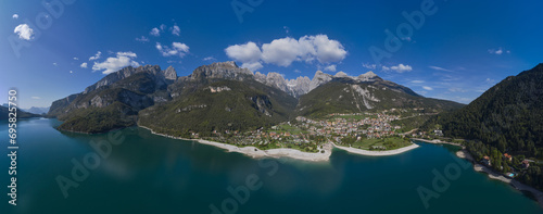 Aerial view of Lake Molveno, north of Italy in the background the city of Molveno, campanile basso, cima tosa Italian dolomites. Molveno lake is a beautiful magical place in the Italian Alps.