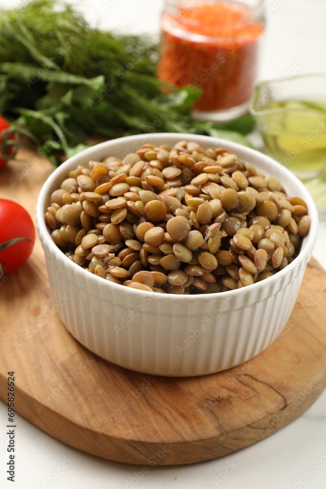 Delicious lentils in bowl served on table, closeup
