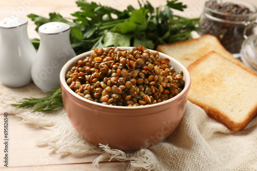 Delicious lentils in bowl served on table  closeup