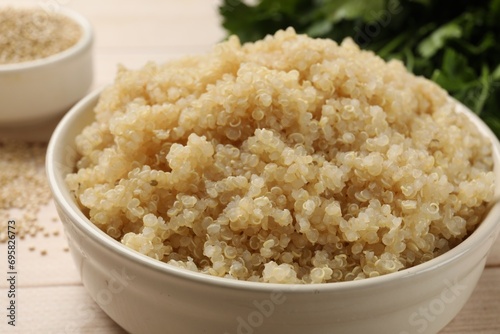 Tasty quinoa porridge in bowl on table, closeup