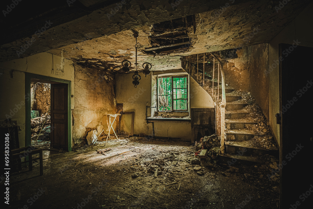 The rotten old house with a missing wall.