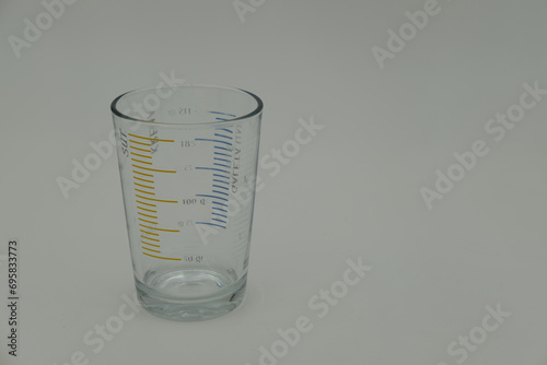 Measuring glass on a white background photo
