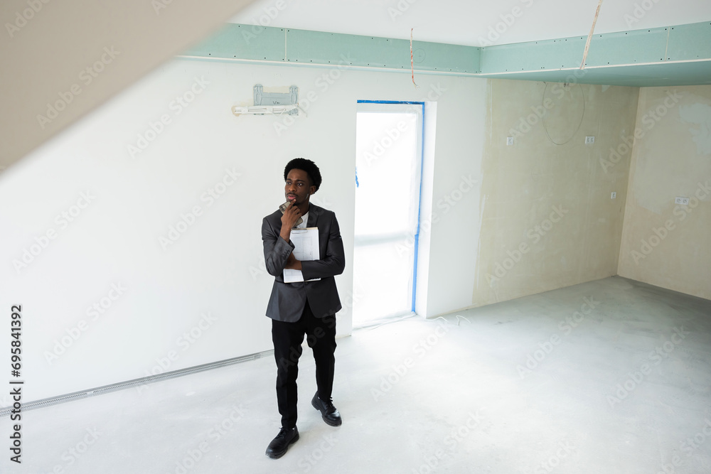 Serious smart clever busy african american dark skinned buisnessman wearing smart casual outfit suit calling someone talking on phone with customers clients. Real estate agent waits for clients. Serious smart clever busy african american dark skinned buisnessman wearing smart casual outfit suit calling someone talking on phone with customers clients. Real estate agent waits for clients.