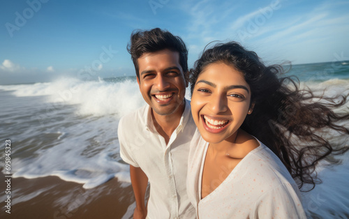young indian couple enjoying at sea beach