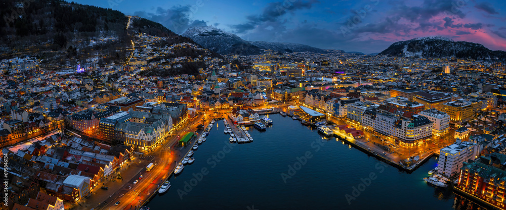 Panoramic aerial view of the illuminated cityscape of Bergen, Norway, during winter dusk time