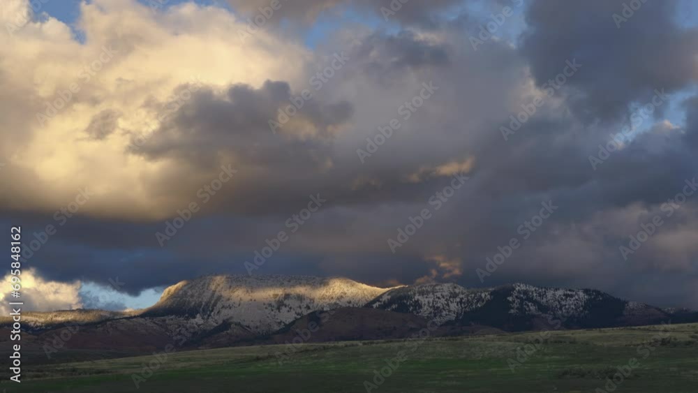 Gloomy Sky With Sunset Clouds Crawling Over Snow Rock Mountains. Timelapse Gloomy Sky With Sunset Clouds Crawling Over Snow Rock Mountains. Timelapse