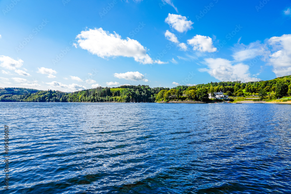 View of the Biggesee near Attendorn in the Olpe district with the surrounding nature. Landscape by the lake in the Sauerland. Bigge Dam.
View of the Biggesee near Attendorn in the Olpe district with the surrounding nature. Landscape by the lake in the Sauerland. Bigge Dam.