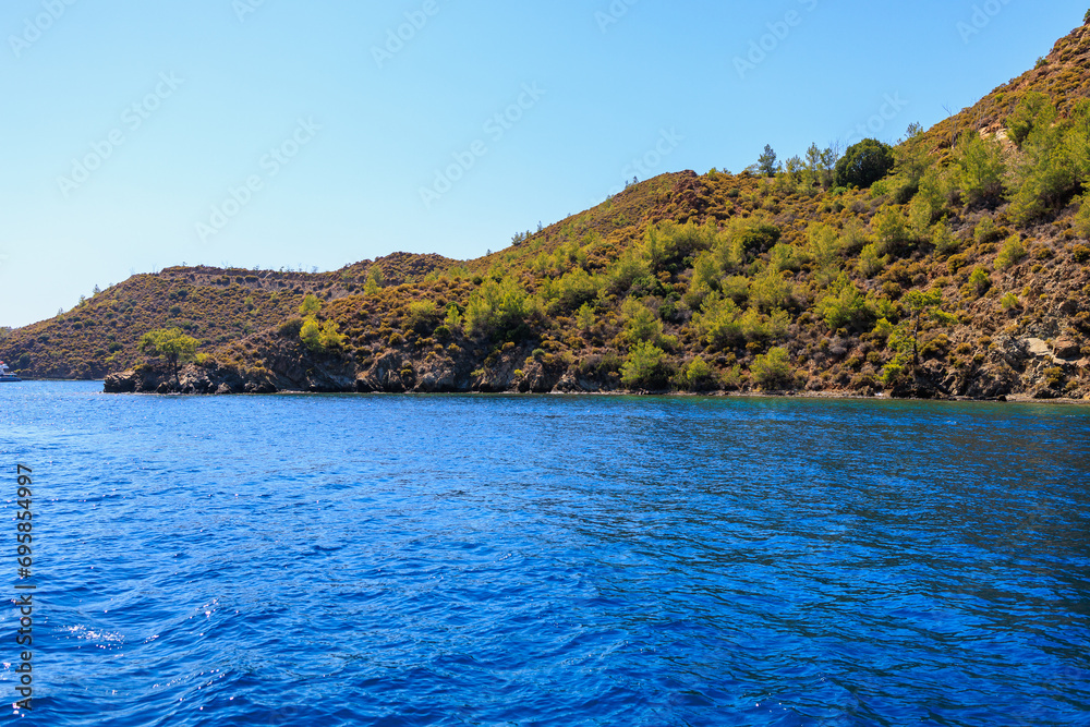Rocky coast in the resort part of the Mediterranean or Aegean Sea. Background with selective focus and copy space Rocky coast in the resort part of the Mediterranean or Aegean Sea. Background with selective focus and copy space