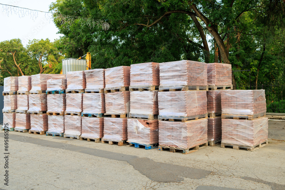 Pallets with paving slabs. Background with selective focus and copy space Pallets with paving slabs. Background with selective focus and copy space