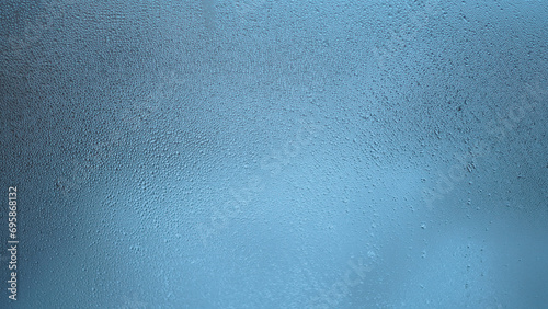 Condensation on window glass in frosty winter weather. Background in the form of small drops on the glass.
