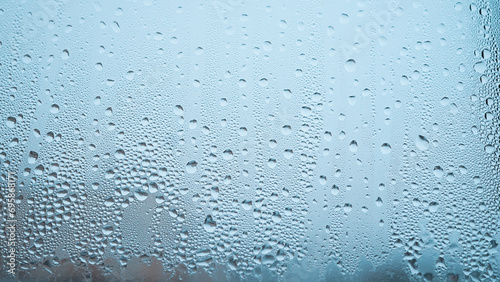 Condensation on window glass in frosty winter weather. Background in the form of small drops on the glass.