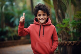 little boy showing thumbs up