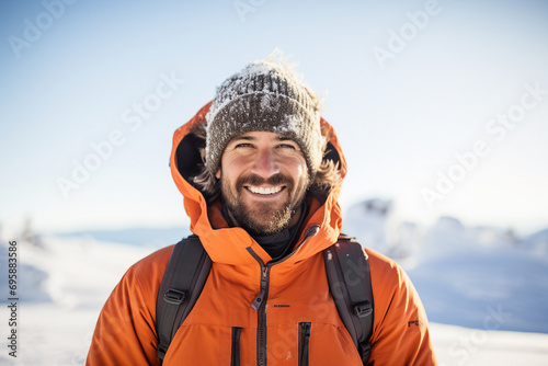 Portrait of cheerful man climber with backpack standing on high snowy mountains on winter day generative AI