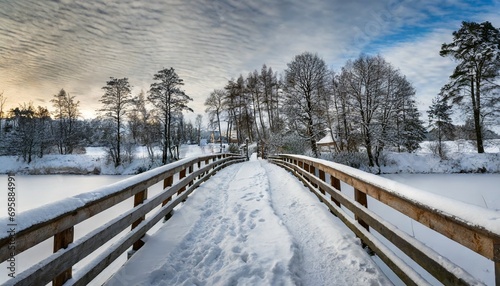 snowy wooden bridge in a winter day stare juchy poland