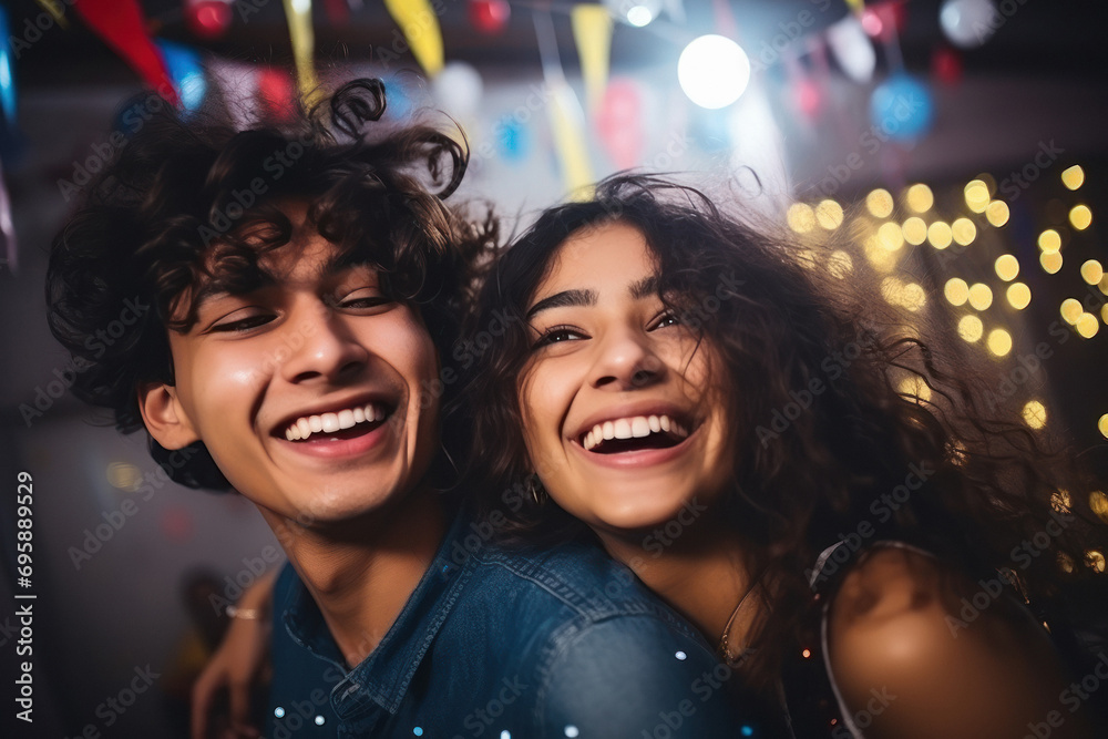 Fototapeta premium young Indian couple, are laughing and joyful dancing at party
